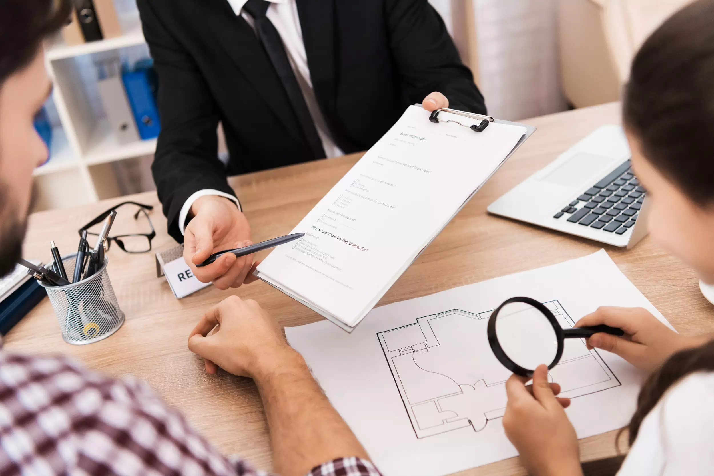 A realtor sharing documents with new homeowners